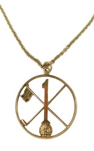 A 9ct gold golfing pendant and chain, the disc medallion of a crossed club and flag, with ball...