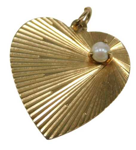 A heart shaped pendant, with etched star detail around a cultured pearl, in three claw clasp...