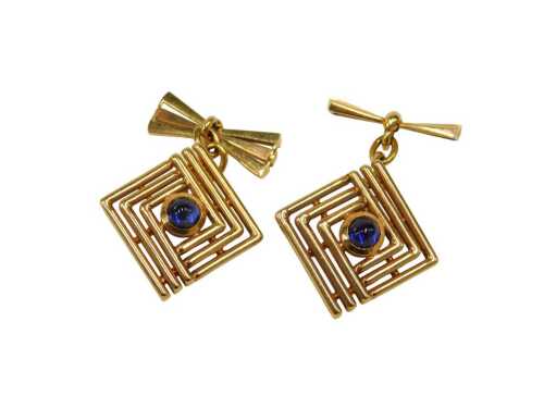 A pair of abstract cufflinks, the square three row two sectional designed head centred by a...