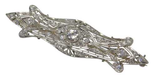 An Art Deco diamond bar brooch, centred by a round brilliant cut diamond, 5.6mm x 5.6mm x 2.8mm,...