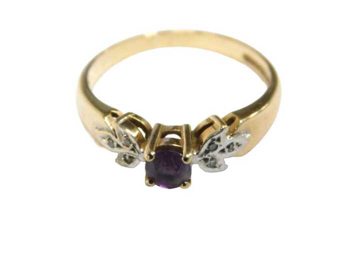 A 9ct gold dress ring, with round brilliant cut amethyst, leaf white gold moulded shoulders,...