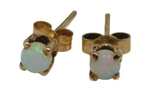 A pair of 9ct gold opal stud earrings, each set with round brilliant cut opal, in four claw...