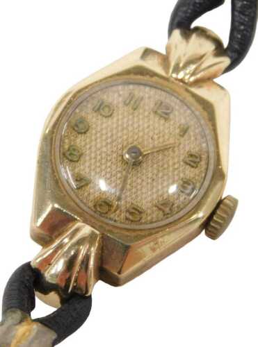 A 9ct gold cased lady's wristwatch, the octagonal outer case with a circular numeric dial, on a...