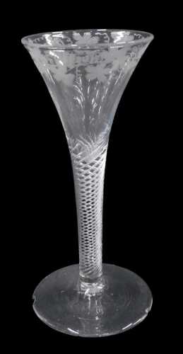 An English ale glass, the bell shaped bowl, delicately etched with berries and flowers, on a...