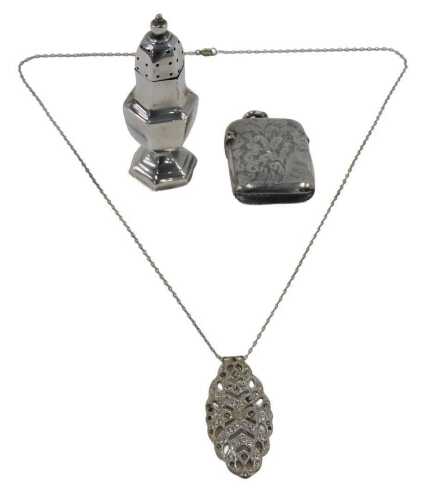 A Victorian silver vesta case, of oblong form, with plain ring top and hinged lid, chased with...