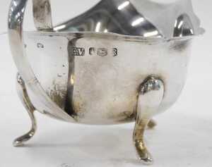 An Elizabeth II silver sauce boat, with flared rim, ear shaped handle, on triple hoof feet, by... - 2