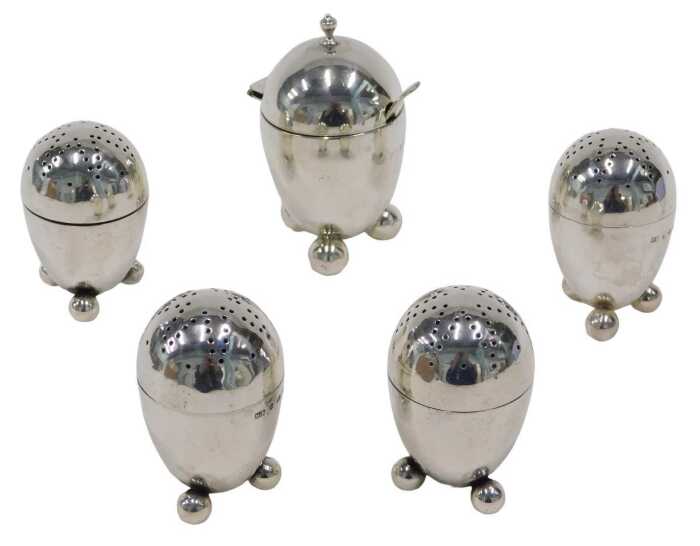 A set of four Victorian silver pepper pots, each of domed form, with pierced screw tops, on...