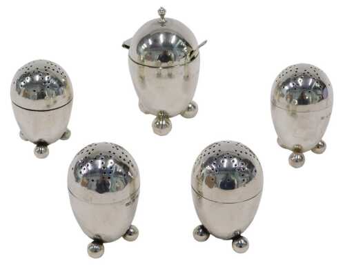 A set of four Victorian silver pepper pots, each of domed form, with pierced screw tops, on...