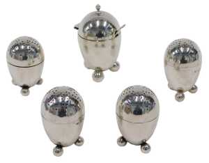 A set of four Victorian silver pepper pots, each of domed form, with pierced screw tops, on...