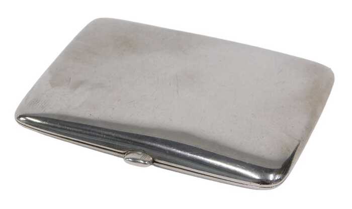 A George V silver card case, of oblong form with thumb mould handle and plain interior, by...