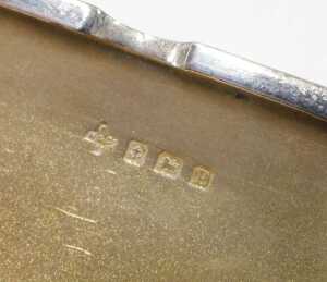 A George V silver card case, of oblong form with thumb mould handle and plain interior, by... - 2