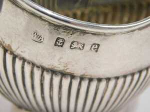 An Edward VII silver cream jug, of small proportion, with shaped spout, strapwork handle, part... - 2