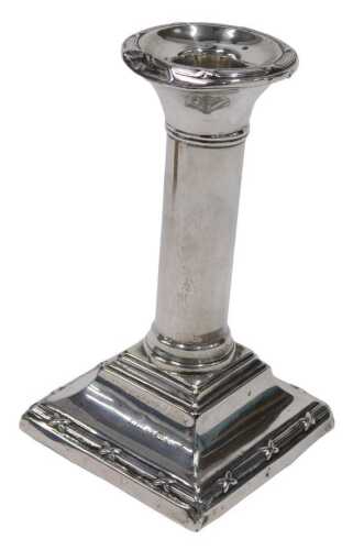 A 20thC silver candlestick, with circular sconce and cylindrical stem on stepped base, marks...
