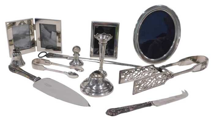 An Elizabeth II silver photograph frame, of plain oval form, with easel back, the opening for...