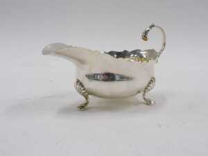 A George V sauceboat, with flying acanthus leaf handle, flared rim and triple hoof feet, by H H... - 4