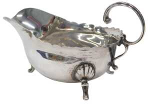 A Victorian silver cream jug, of miniature form, with S scroll handle, flared rim and triple...
