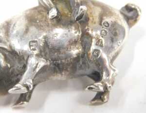 A late 19thC miniature figure group of a cherub riding pig, Chester import marks 1898, 3cm high,... - 4