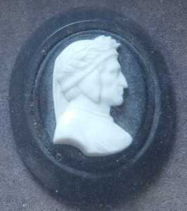 A 19thC carved ivory miniature portrait of a Renaissance gentleman in profile, on ebonised oval... - 2
