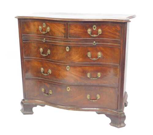 A George III mahogany serpentine bachelor's chest, with moulded top over two drawers, over...