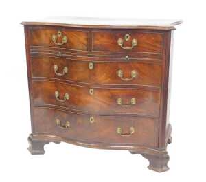A George III mahogany serpentine bachelor's chest, with moulded top over two drawers, over...