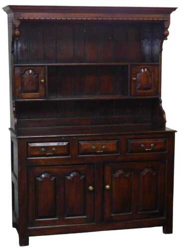 An 18thC style oak dresser, with an outswept overhanging pediment, above one long and two short...