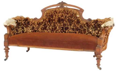 A Victorian mahogany three-seater showframe sofa, with a foliate and floral carved topped crest...