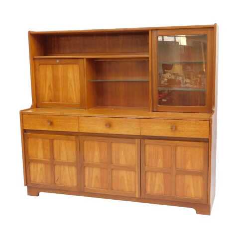 A Nathan teak sideboard, the top with a single shelf above a fall flanked by a glass shelf,...