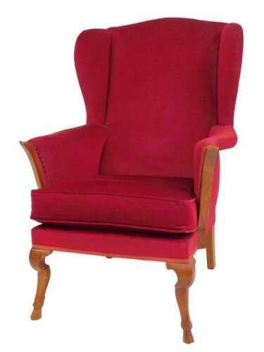A Criterion Cord oak-framed wingback chair, upholstered in red draylon fabric, raised on...