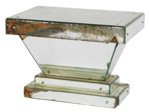 An Art Deco mirrored glass occasional table, of rectangular, hourglass form, 51cm high, 70cm...
