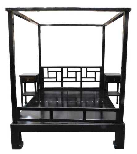 An ebonised Oriental style four poster bed, with a pierced rectangular repeat decoration...