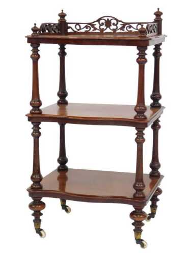 A Victorian mahogany whatnot, with a pierced, scrolling, galleried top and turned finials, the...