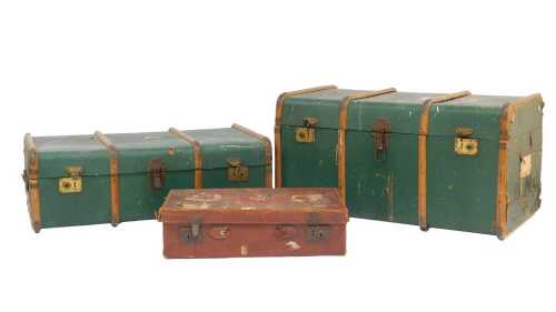 Two early 20thC green wooden-bound travelling trunks, 92cm wide, together with a brown leather...