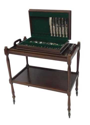 An early 20thC mahogany two tier tray top trolley, each tier with raised sides, united by...