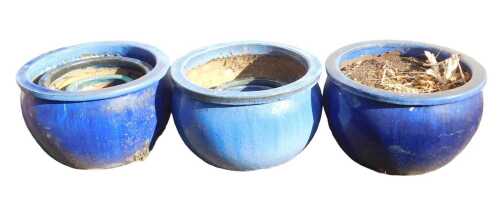 A group of blue glazed plant pots, including a pair of dark blue examples, of bellied form, 52cm...