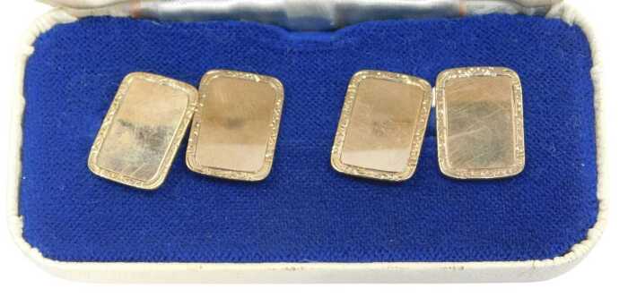 A pair of Elizabeth II 9ct gold rectangular cufflinks, each with an engine-turned border and...