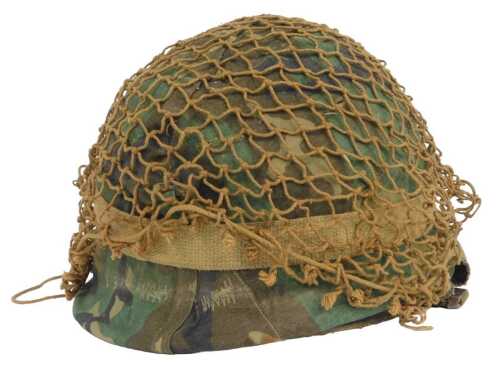 An American post-war Vietnam period helmet, with camouflage cover and helmet liner, 24cm x 29cm.