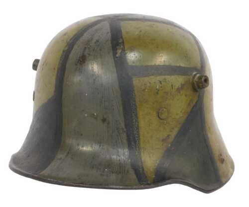 A German First World War M16 helmet, with panelled camouflage decoration, tan leather interior...