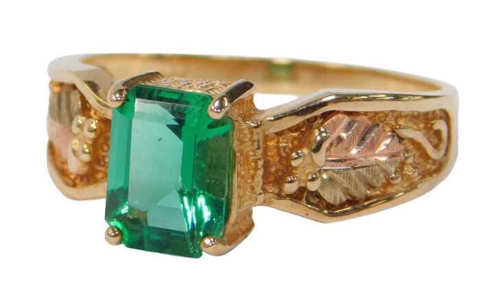 A 9ct gold QVC dress ring, set with a light green rectangular cut stone, possibly spinel, with a...