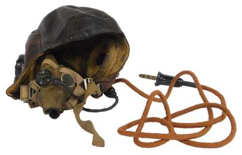 An RAF Type C flying helmet, with headphones stamped with Air Ministry sign and numbered...