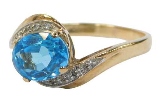 A 9ct gold QVC dress ring, centred with an oval cut aquamarine, and cz set shoulders, on a...