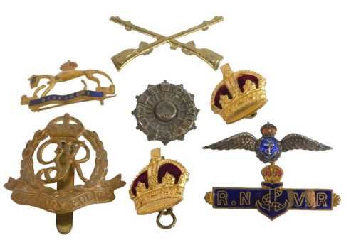 A collection of military cap badges, etc., to include Berkshire Regiment, Military Police, the...