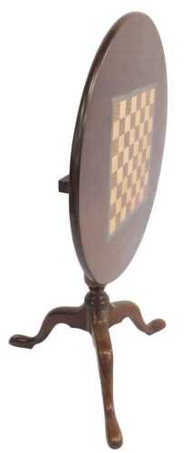 A mahogany games table, the circular top inlaid with a parquetry chessboard, on a 19thC turned...