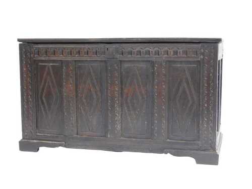 A late 17th/early 18thC oak coffer, the planked top above a frieze carved with flutes, and three...