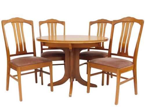 A 1970s/80s teak circular extending dining table, on a shaped quadruple support, with splayed...