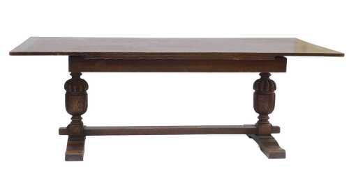 An oak refectory table, the rectangular planked top, on cup and cover turned supports, with...