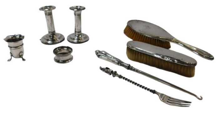 A group of small silver and silver-mounted items, including a silver-mounted hairbrush and...