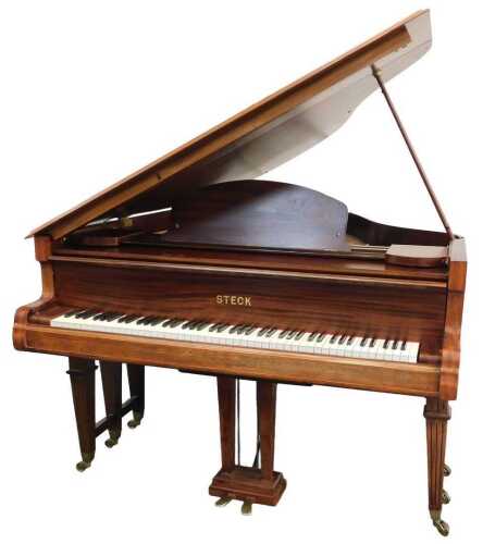 A Steck mahogany cased baby grand piano.