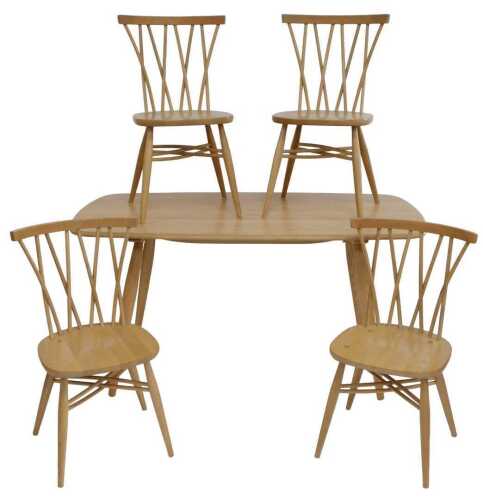 A light coloured Ercol dining table, the rectangular top with rounded sides, ends and corners,...
