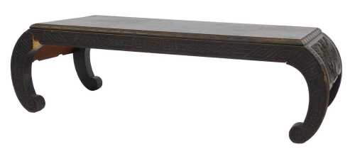 An ebonised Chinese hardwood low table, the rectangular top with carved border, on shaped legs,...