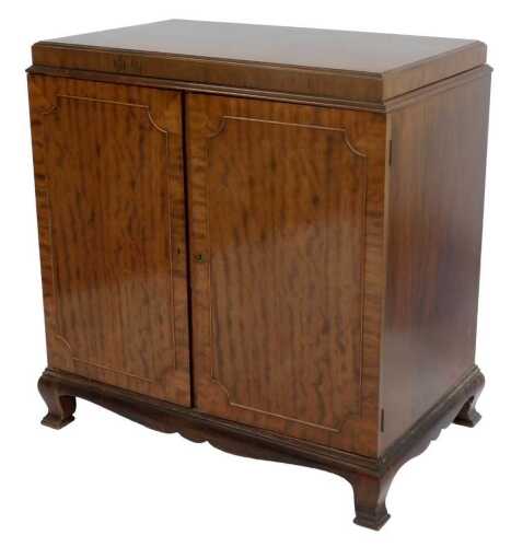 A mahogany side cabinet, having two solid doors enclosing a fitted interior with a cellarette...